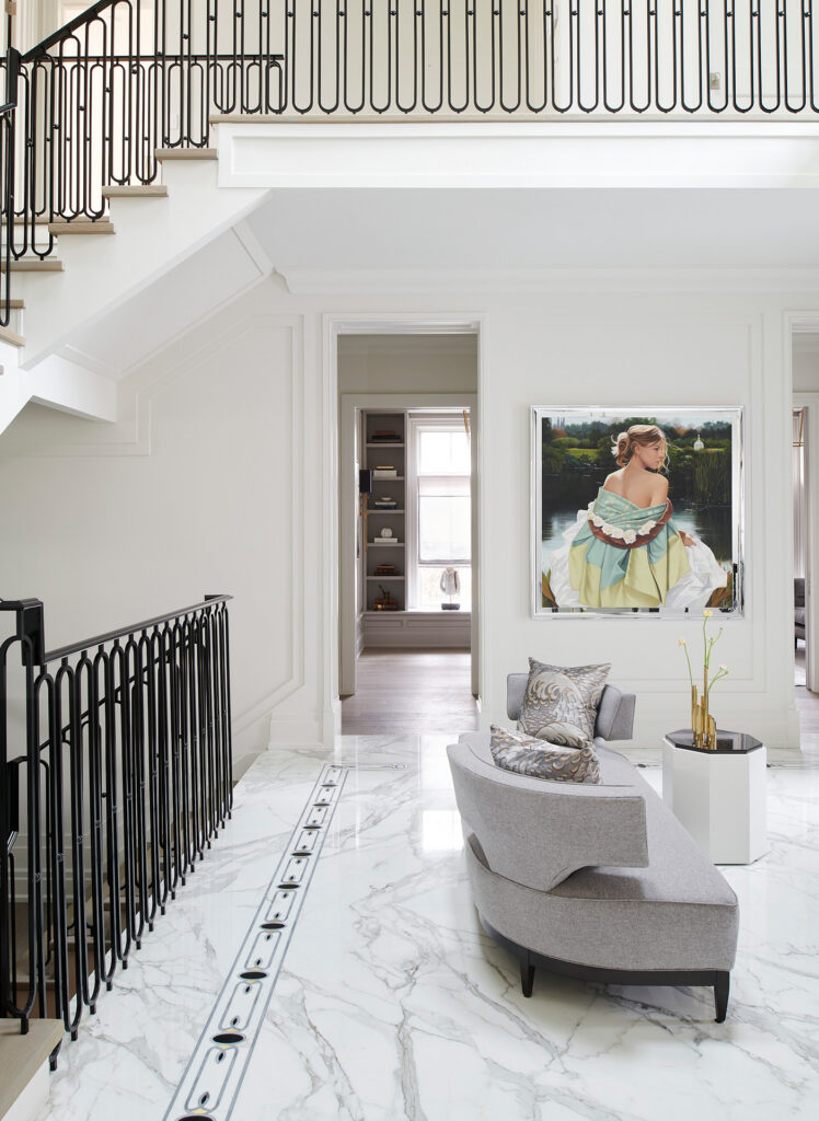 Chateau on the lake - living room with grey couch and large picture of a woman in a colorful dress