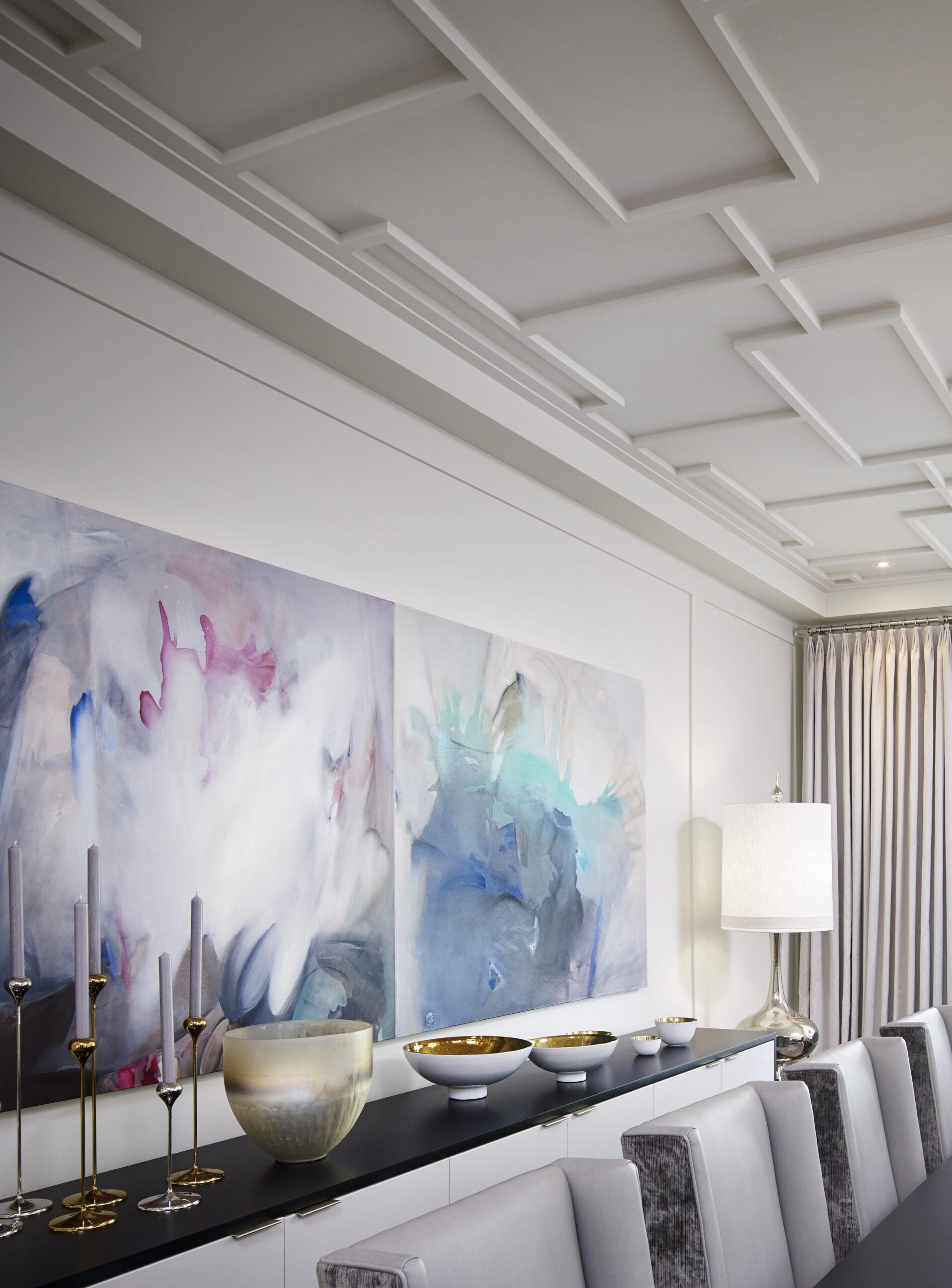 A dining room with colorful paintings on the wall