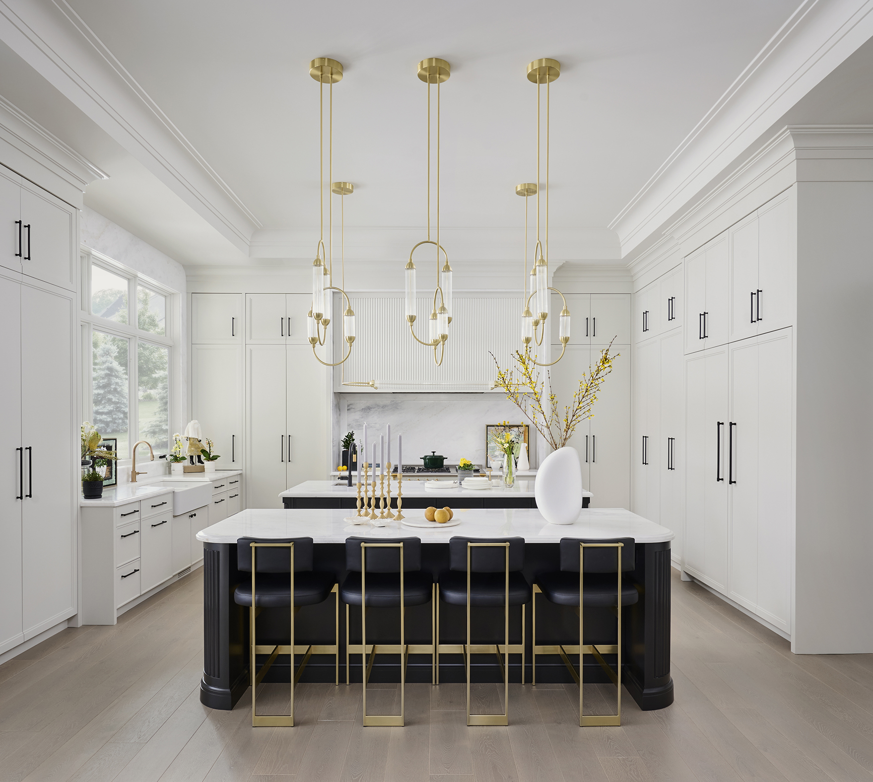 Black tie kitchen with a white marble island and white cabinets
