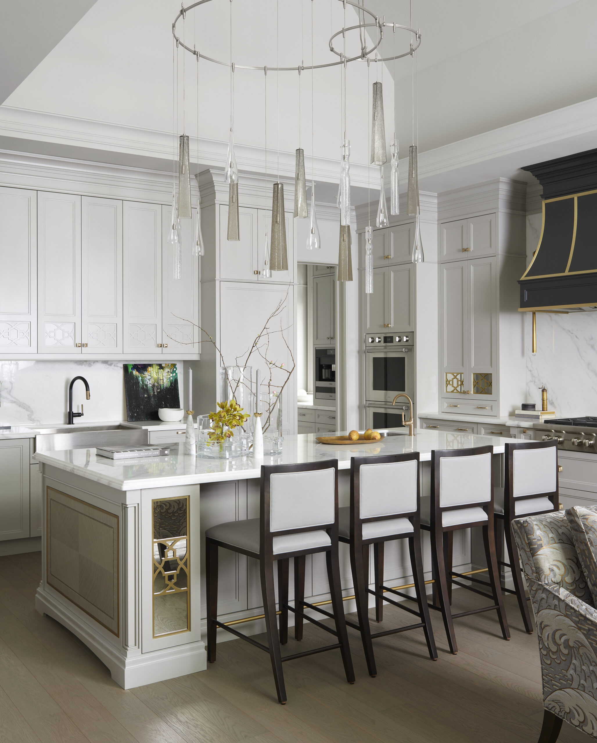 A modern kitchen with bar stools around the kitchen island