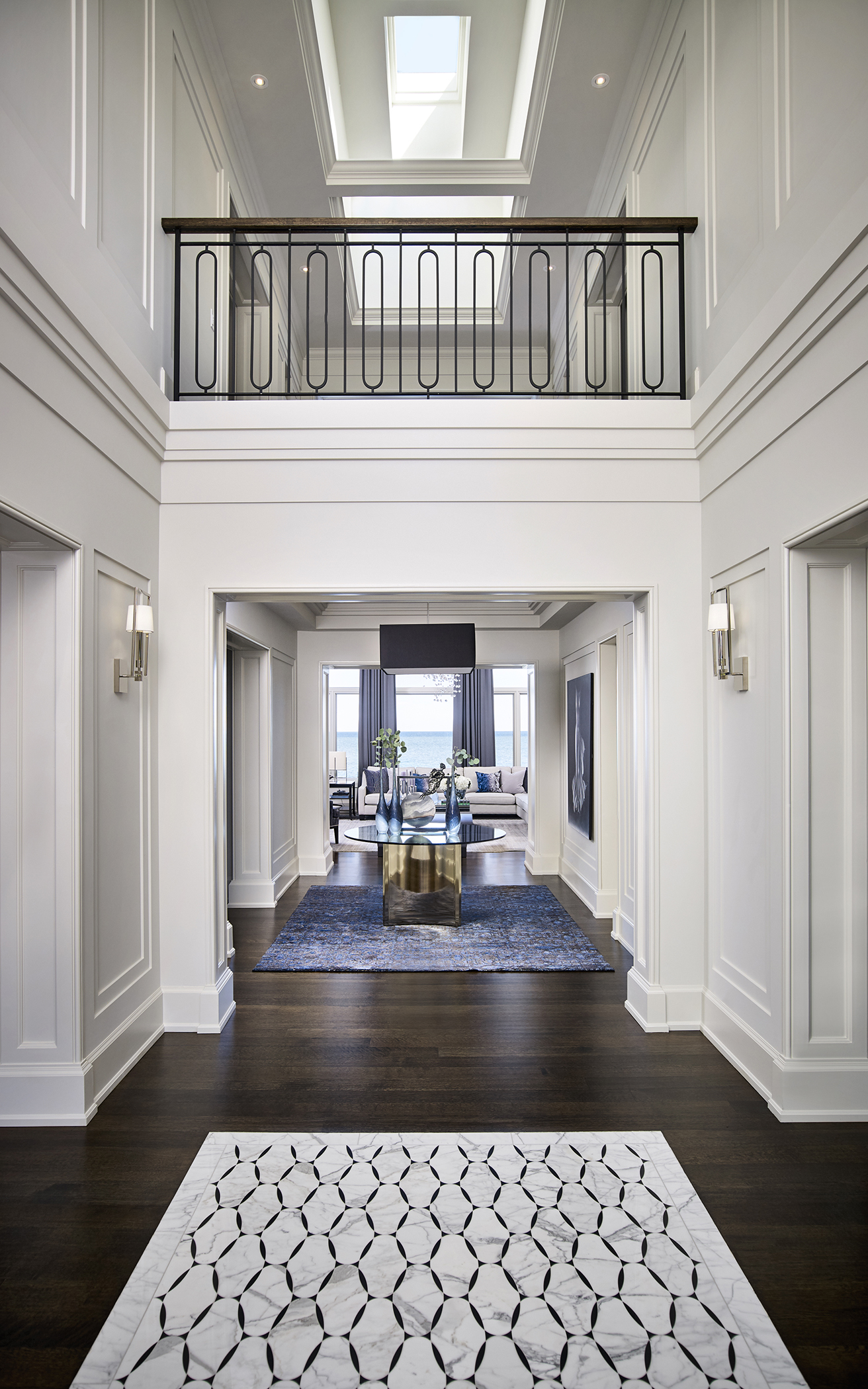Hallway leading to living room with view of second floor