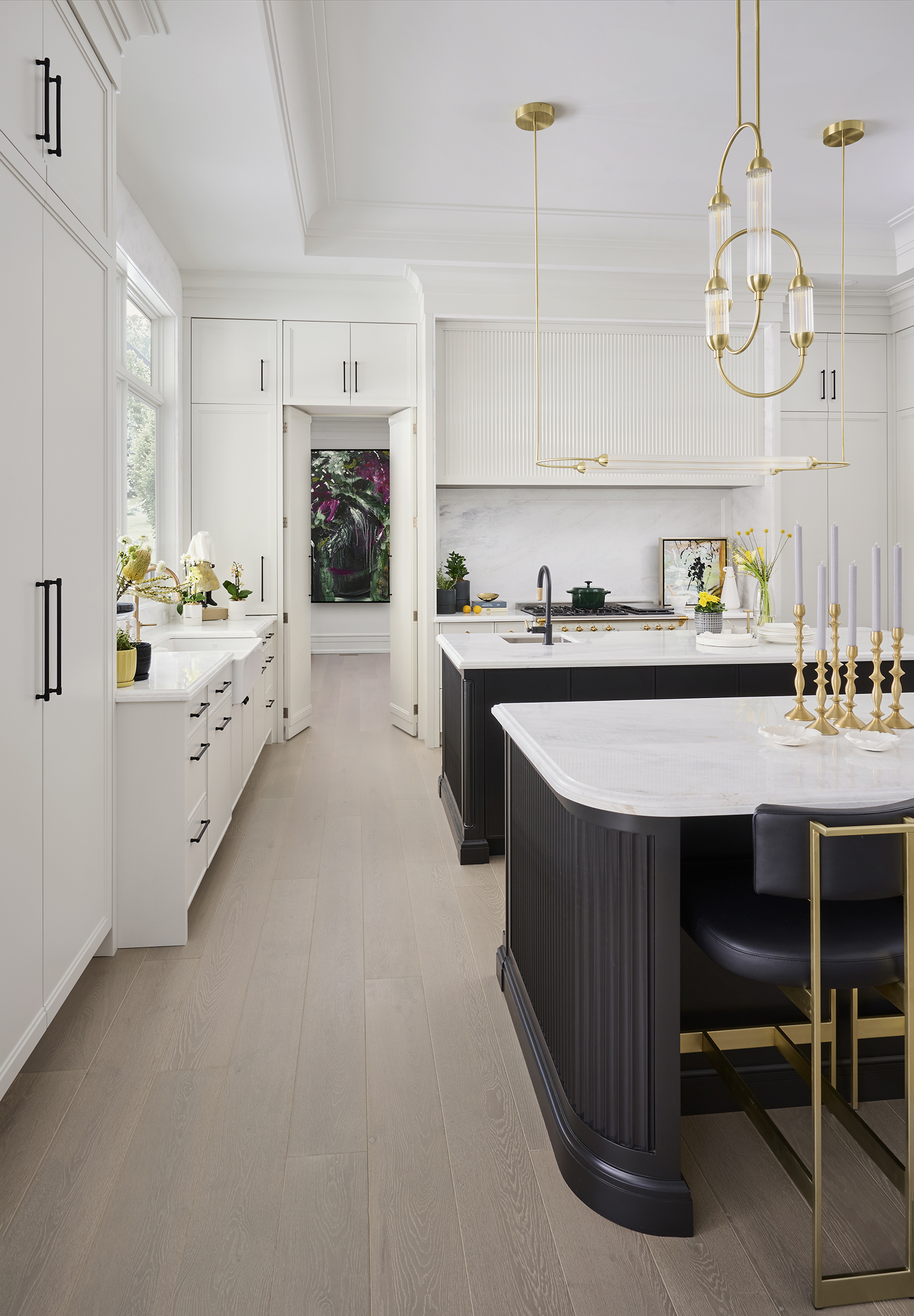 Two black kitchen islands with white marble countertops