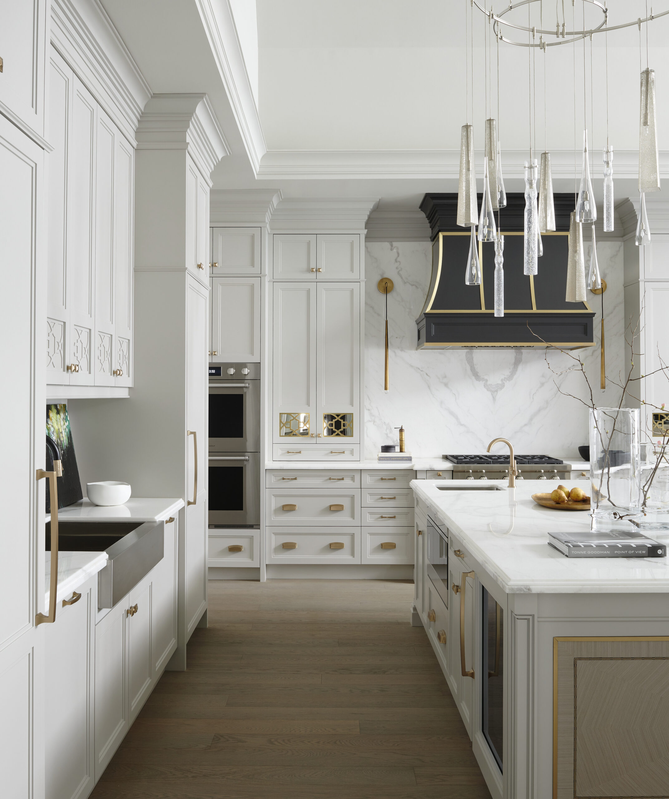 A modern kitchen with marble top kitchen island