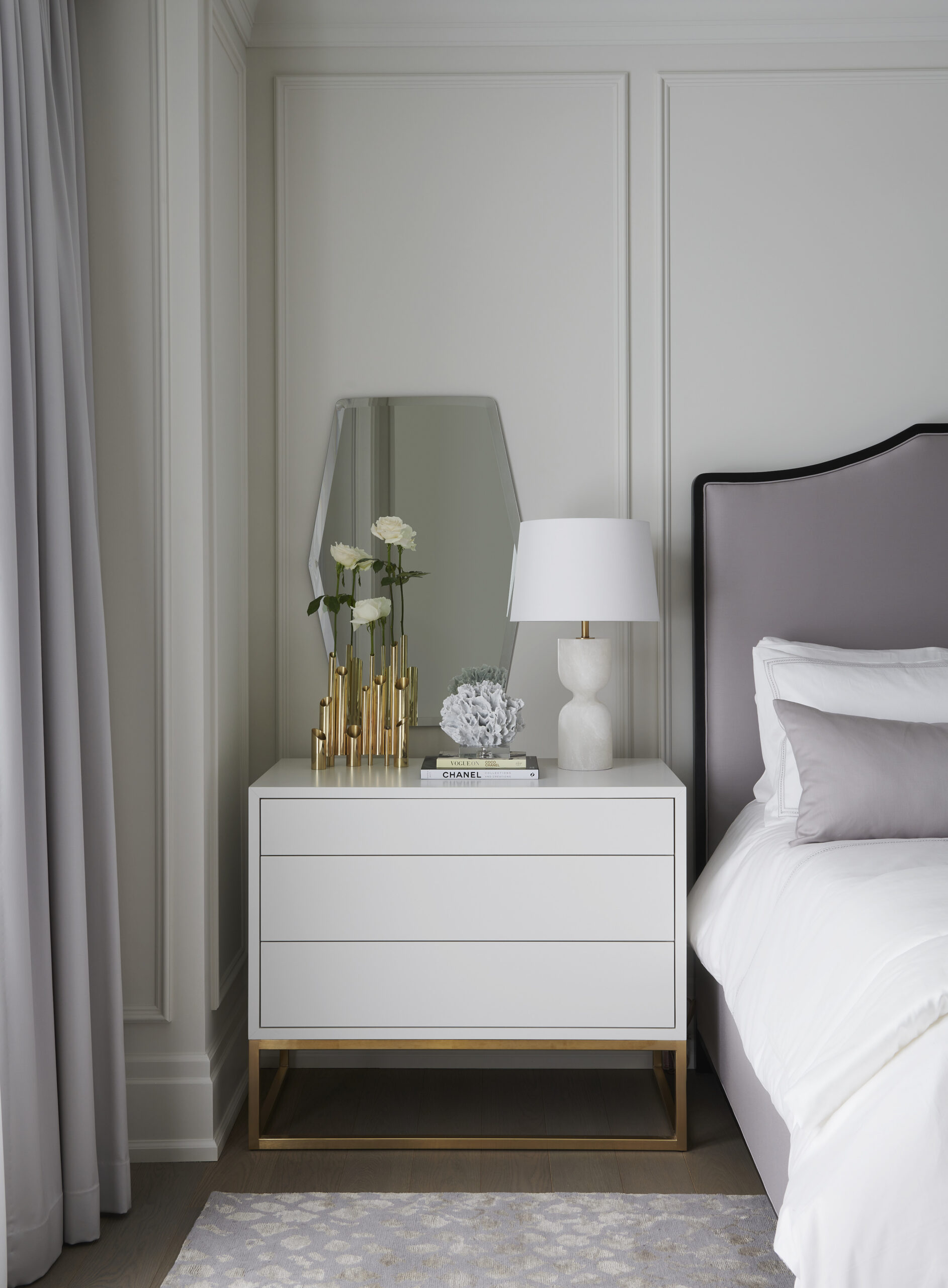 White bedside table with a lamp