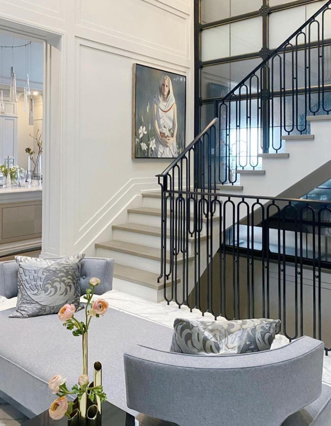 A grey couch beside stairs