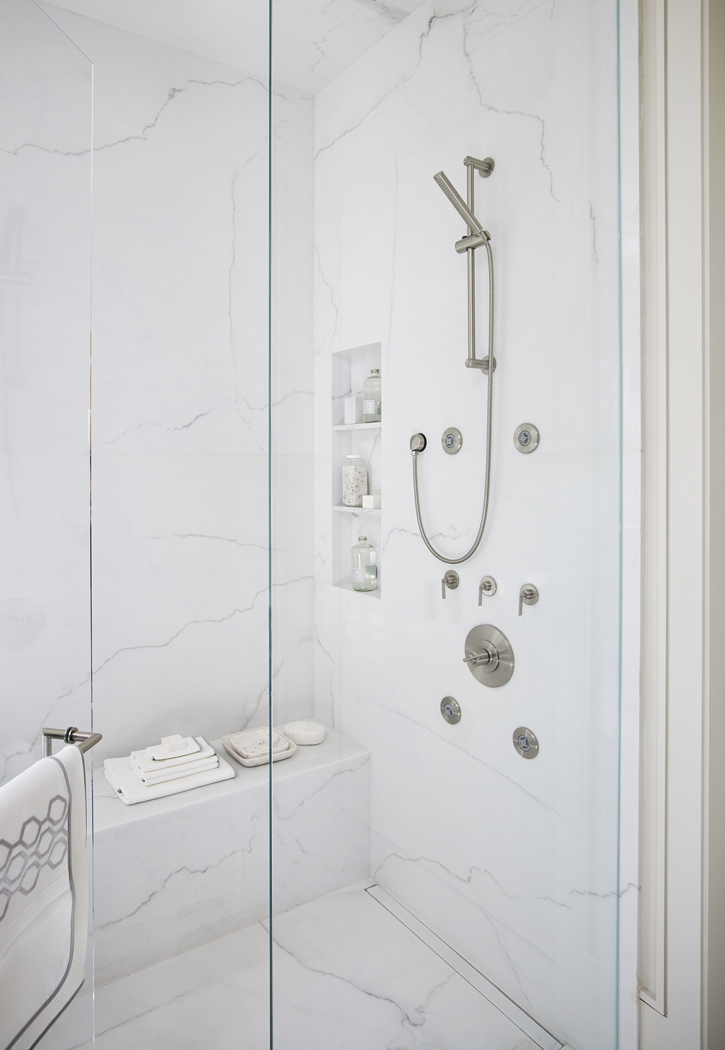 Glass shower with white marble
