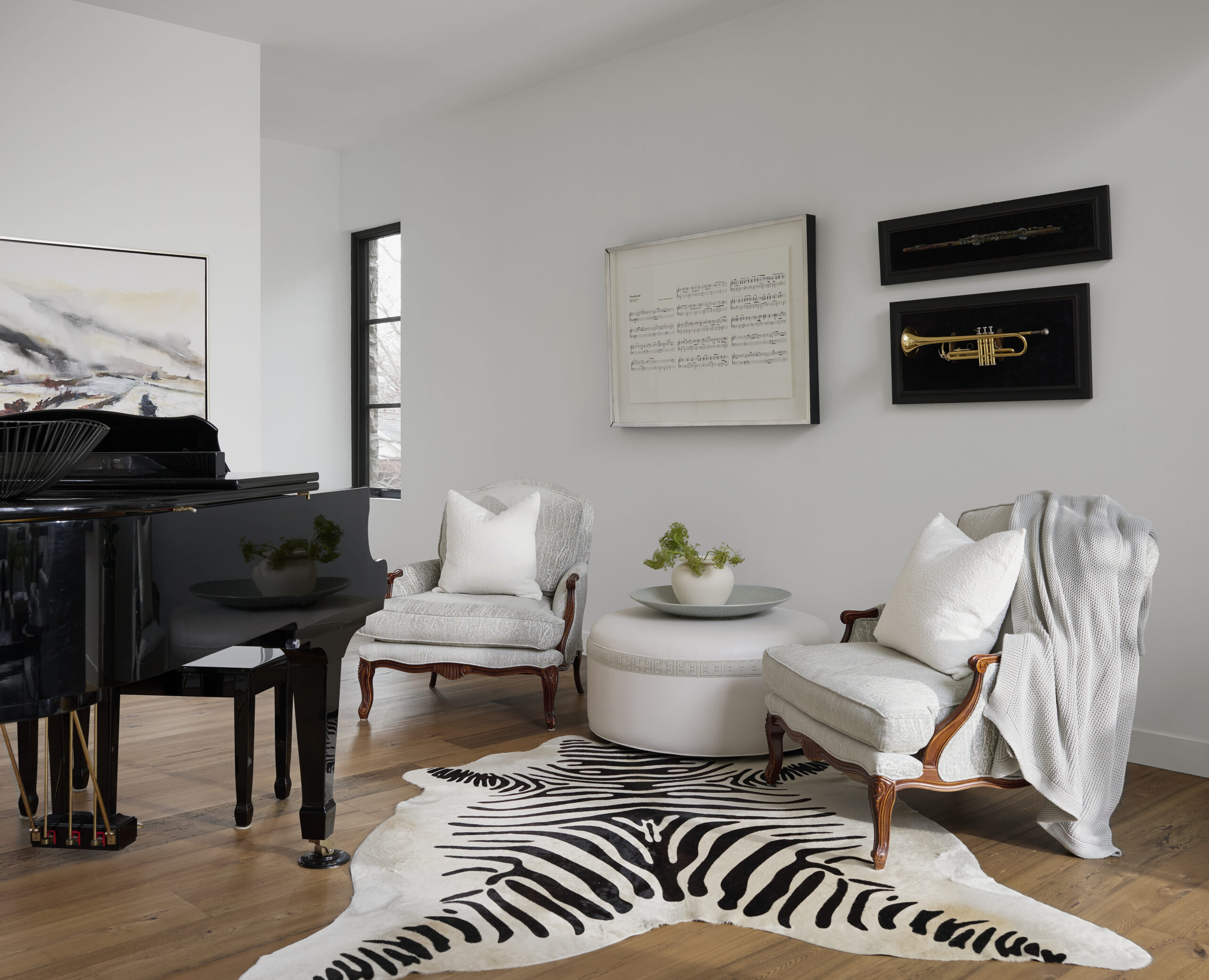 Sitting area with grand piano and two chairs