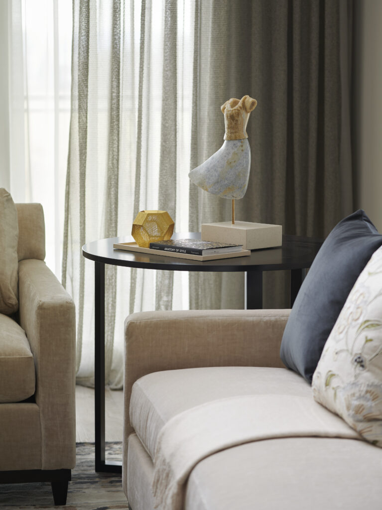 Side table with sculpture of a yellow dress with a flowery skirt