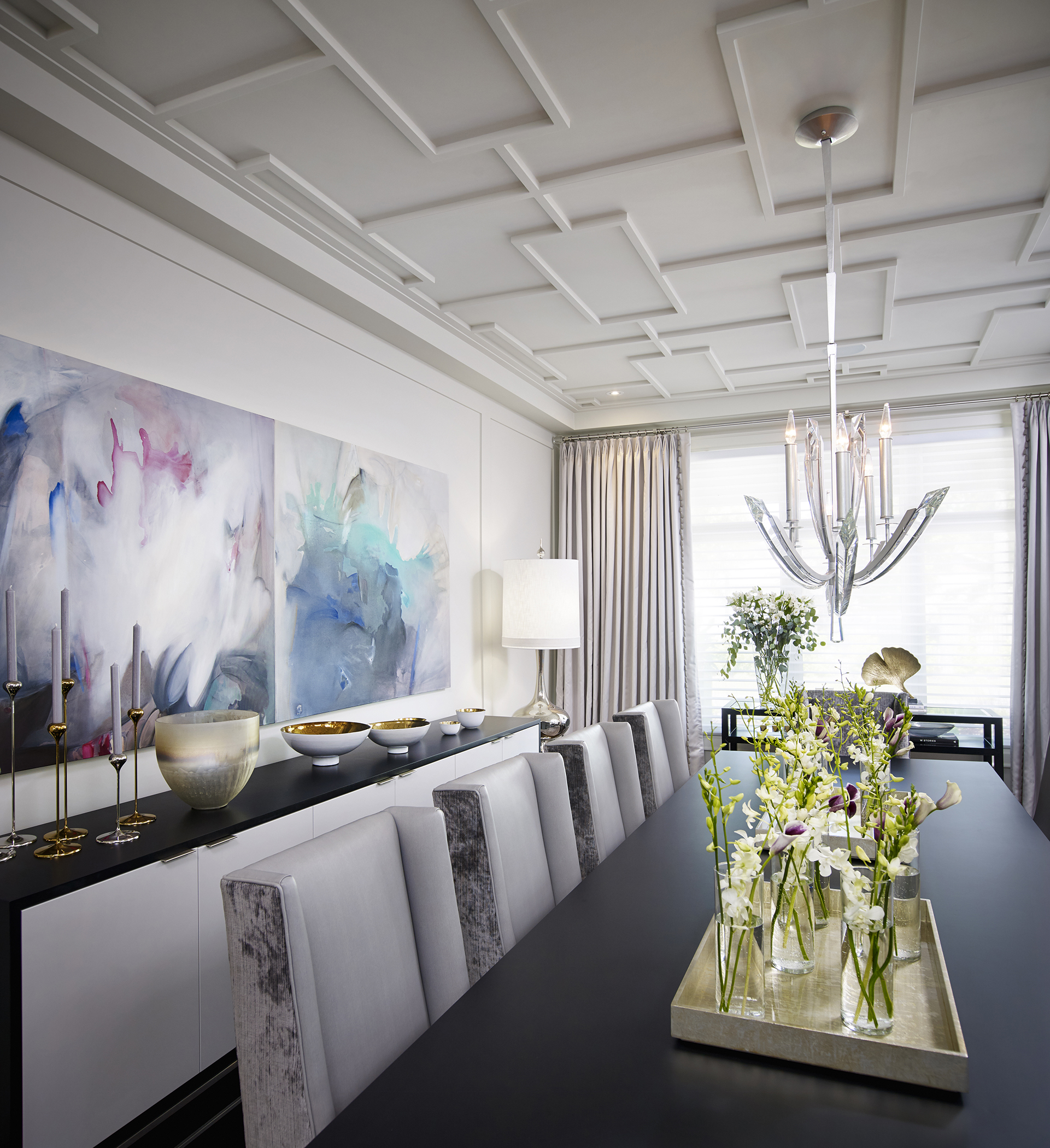 A dining room with colorful paintings on the wall
