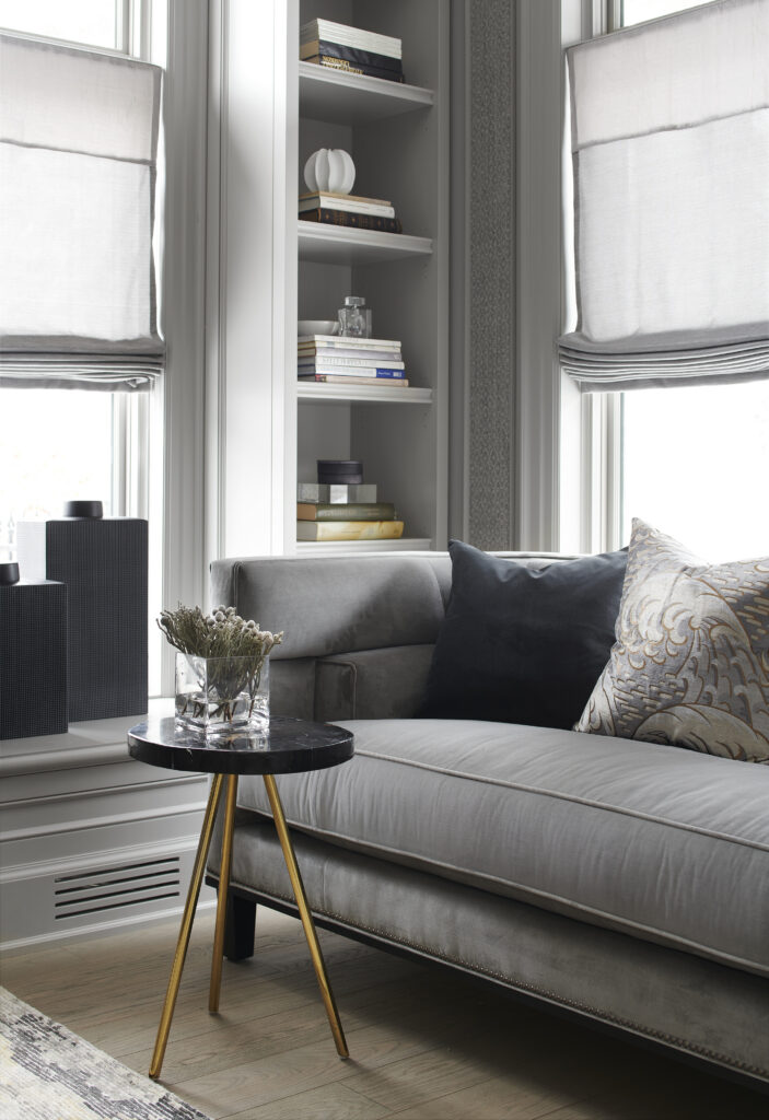 Chateau on the Lake - Grey couch and a black table with gold legs